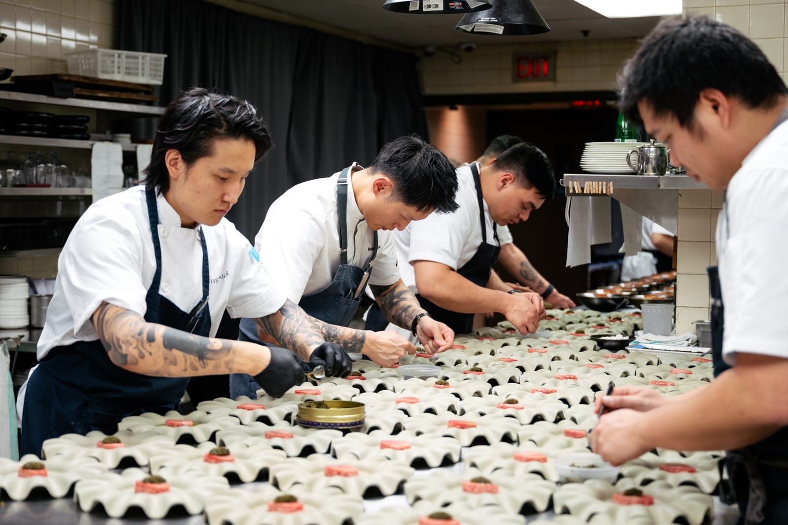Cooks plating canapés at Five Sails